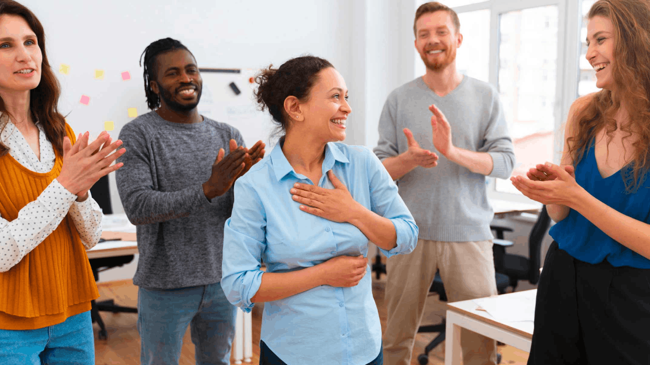 Colleagues bidding farewell claps to co-workers in a office setup